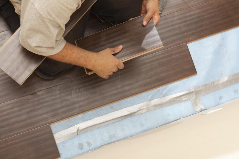 man installing wooden tiles