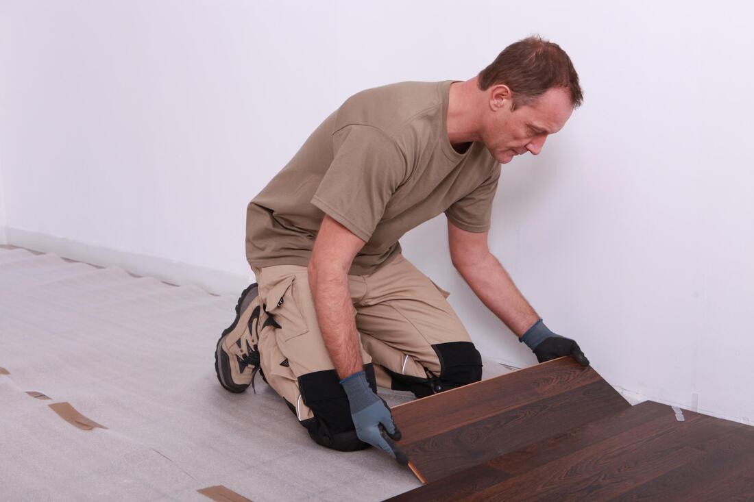 man installing wooden tiles